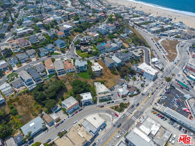 drone / aerial view featuring a water view and a beach view