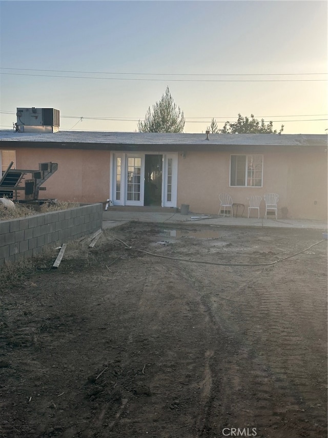 view of front of property featuring central AC unit and a patio