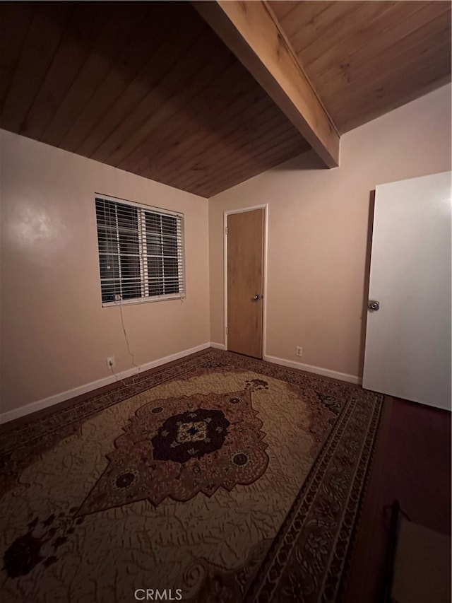 spare room featuring wood ceiling and lofted ceiling with beams