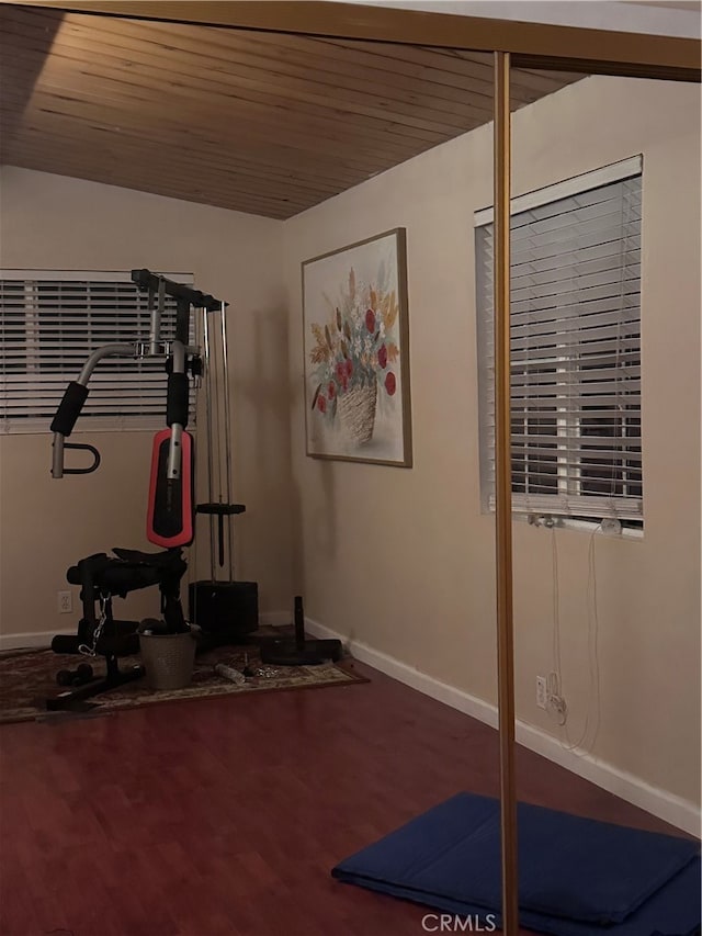 exercise room with wood ceiling and wood-type flooring