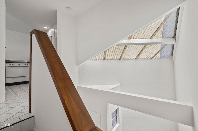 stairway with tile patterned flooring