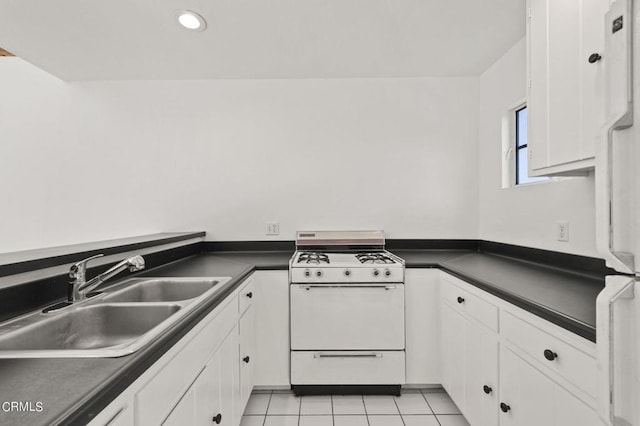 kitchen with white cabinets, light tile patterned flooring, white appliances, and sink