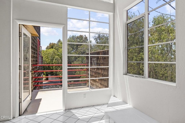 doorway featuring plenty of natural light and light tile patterned flooring