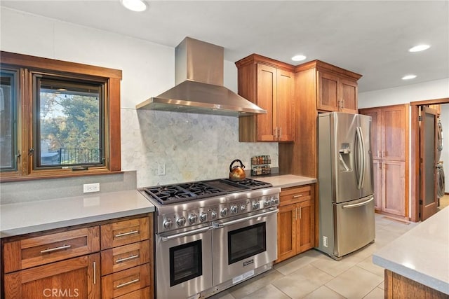 kitchen featuring tasteful backsplash, light tile patterned flooring, wall chimney exhaust hood, and stainless steel appliances