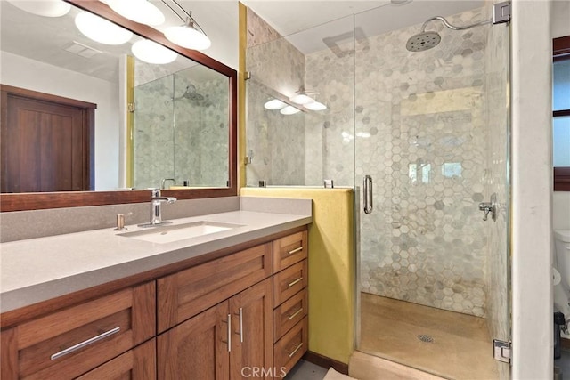 bathroom featuring vanity and a shower with door