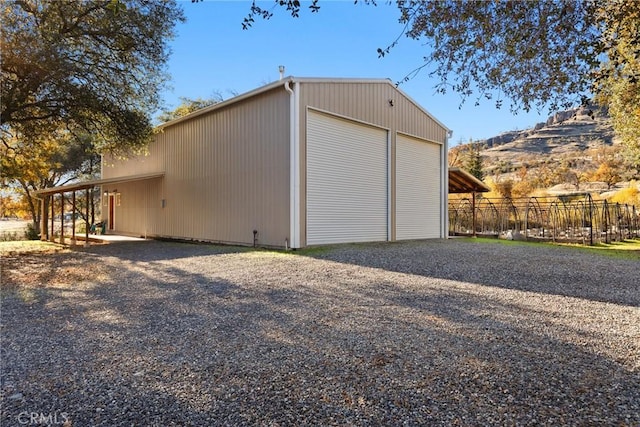 garage with a carport and a mountain view