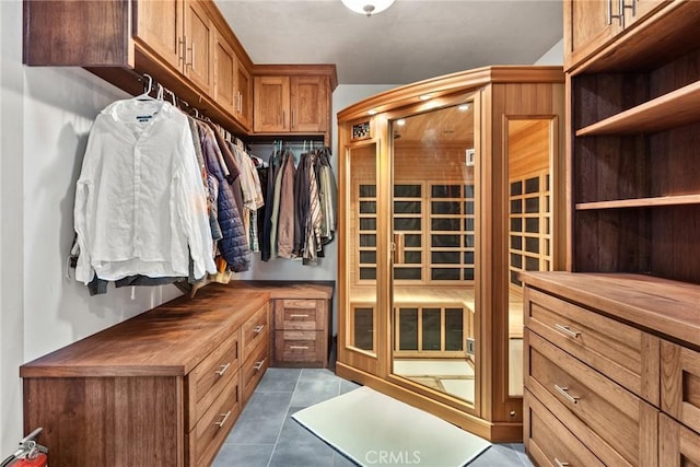 spacious closet featuring dark tile patterned flooring