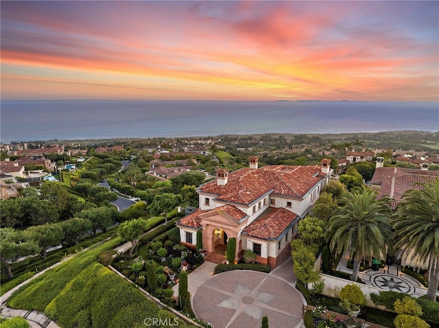 aerial view at dusk with a water view