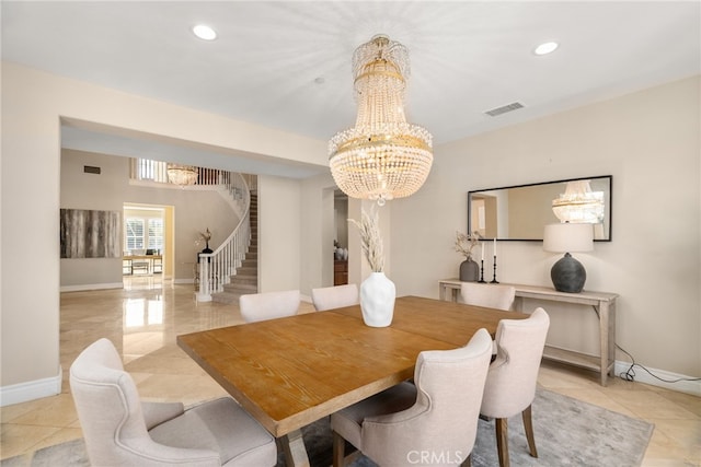 dining area with light tile patterned flooring and an inviting chandelier