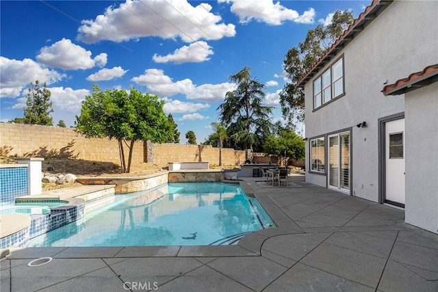 view of pool featuring a patio and an in ground hot tub