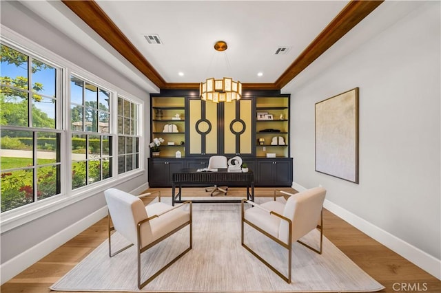 office with ornamental molding, light hardwood / wood-style flooring, and a notable chandelier