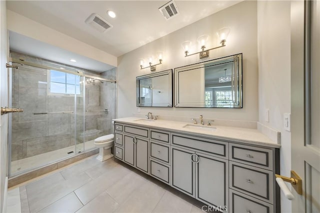 bathroom with tile patterned floors, vanity, toilet, and walk in shower