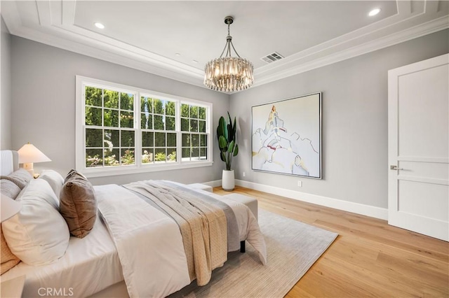 bedroom with multiple windows, crown molding, and light wood-type flooring