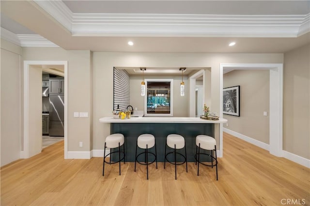 bar with decorative light fixtures, stainless steel fridge, light wood-type flooring, and ornamental molding