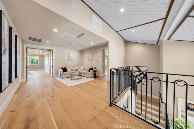 hallway featuring light hardwood / wood-style flooring and wood ceiling