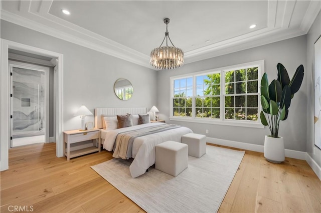 bedroom featuring light hardwood / wood-style floors, crown molding, and an inviting chandelier