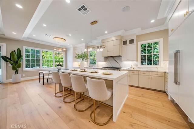 kitchen featuring plenty of natural light, a kitchen island, and light hardwood / wood-style flooring