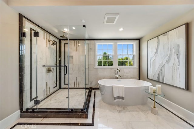 bathroom featuring independent shower and bath