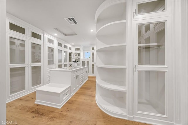 interior space with light hardwood / wood-style flooring and sink