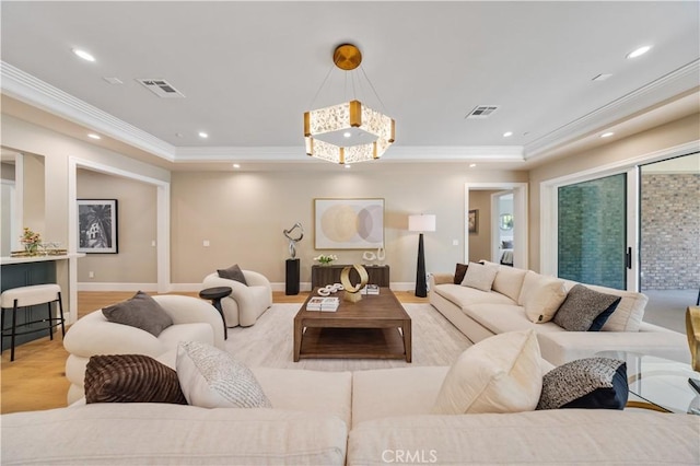 living room with light hardwood / wood-style floors and ornamental molding