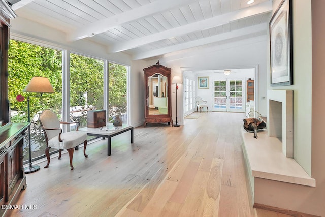 sunroom with a healthy amount of sunlight, vaulted ceiling with beams, and ceiling fan