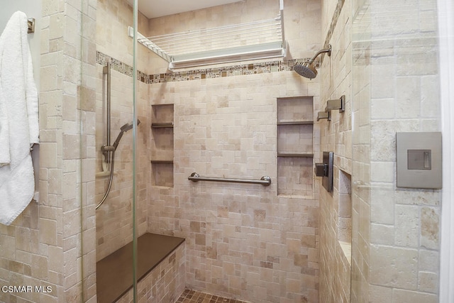 bathroom featuring a tile shower