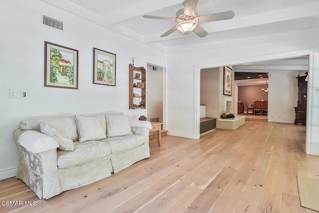 living room with beamed ceiling, wood-type flooring, and ceiling fan