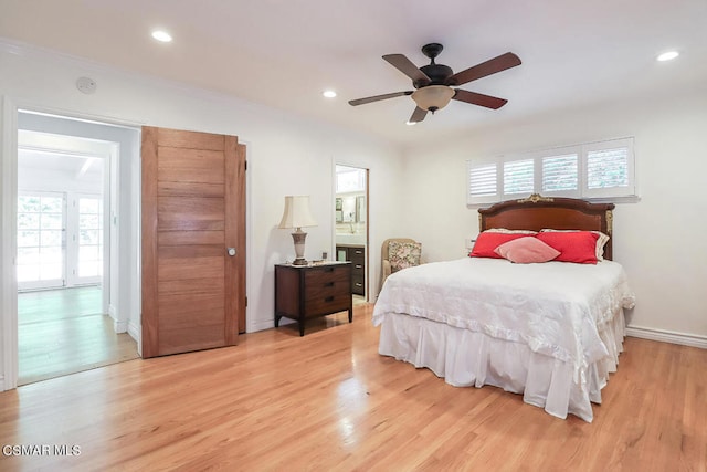 bedroom featuring light hardwood / wood-style flooring, ceiling fan, and crown molding