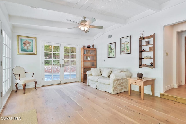 living room featuring beam ceiling, french doors, light wood-type flooring, and ceiling fan