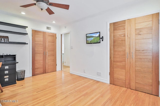 unfurnished bedroom with ceiling fan and light hardwood / wood-style flooring