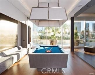 recreation room featuring ornamental molding, hardwood / wood-style floors, a healthy amount of sunlight, and billiards