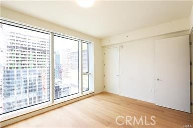 spare room featuring hardwood / wood-style flooring