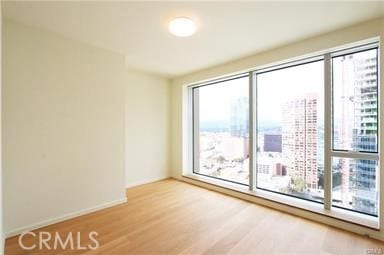 unfurnished room with hardwood / wood-style floors