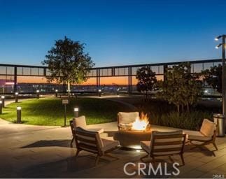 patio terrace at dusk with an outdoor fire pit