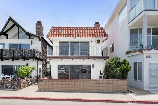 rear view of house featuring a balcony