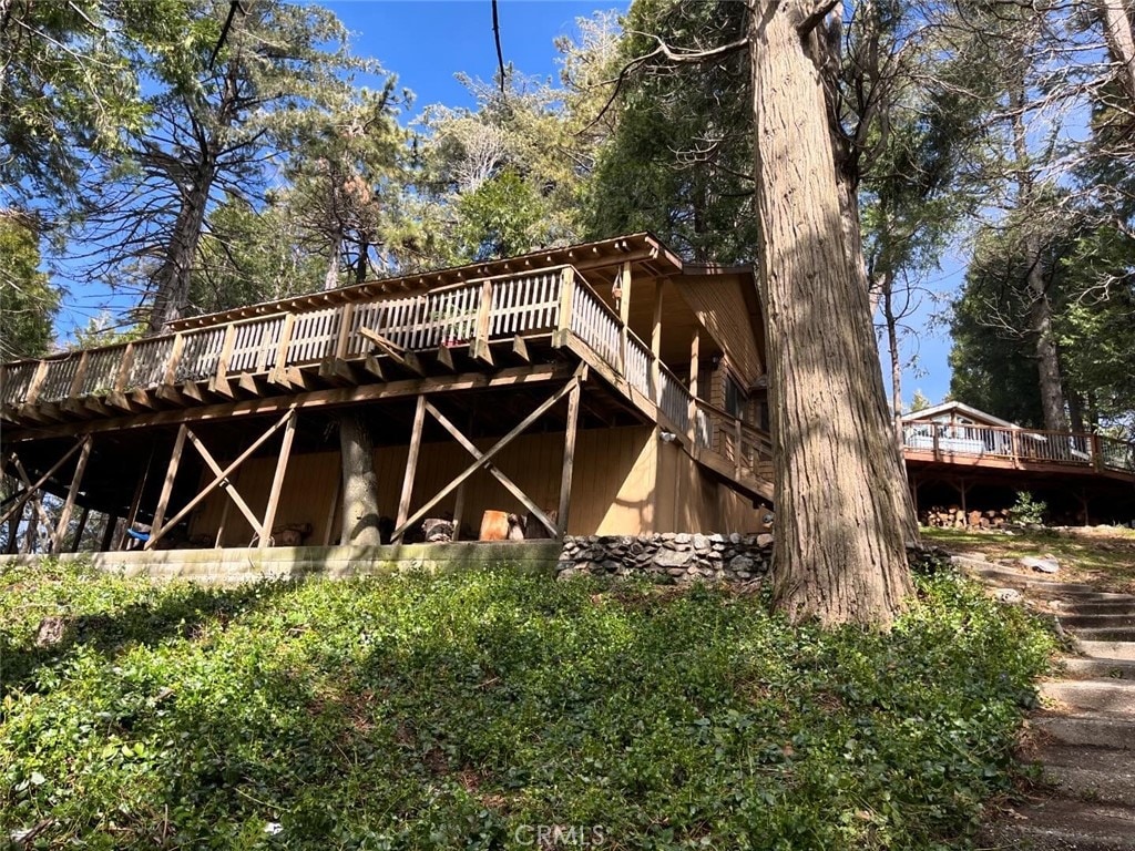 rear view of house featuring a deck