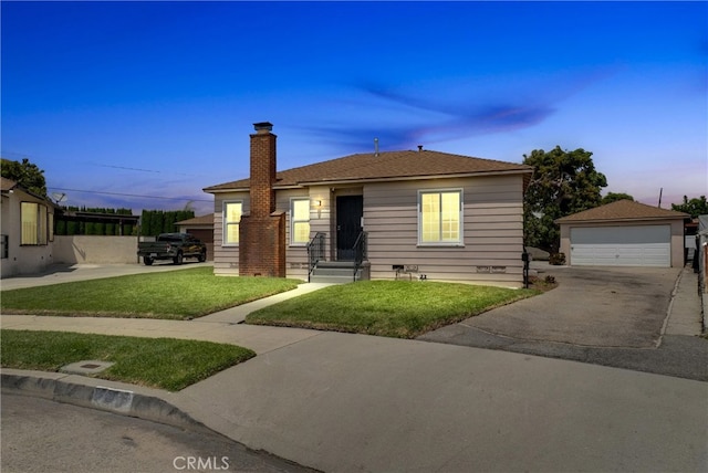 view of front of home featuring an outdoor structure, a garage, and a yard