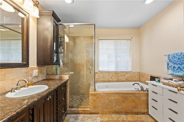 bathroom with vanity and separate shower and tub