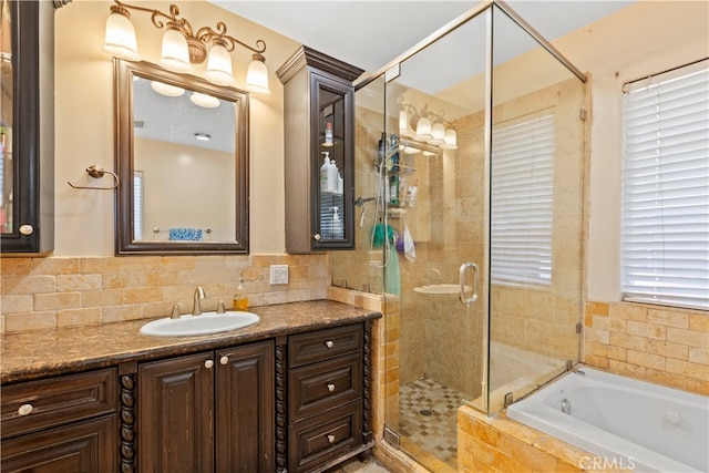 bathroom with vanity and separate shower and tub