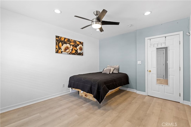 bedroom with ceiling fan and light hardwood / wood-style flooring