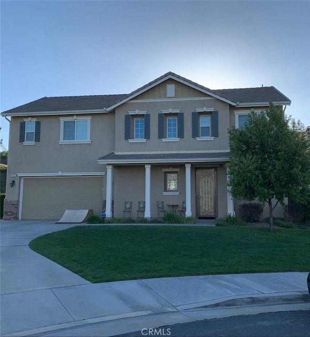 front facade with a front yard and a garage