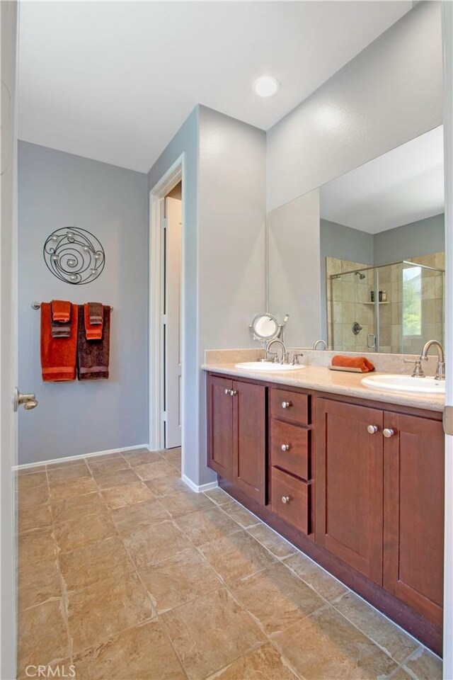 bathroom featuring vanity and a shower with shower door