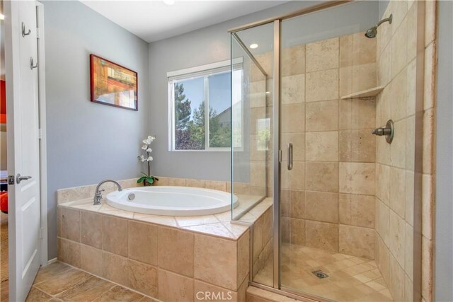 bathroom featuring tile patterned flooring and independent shower and bath