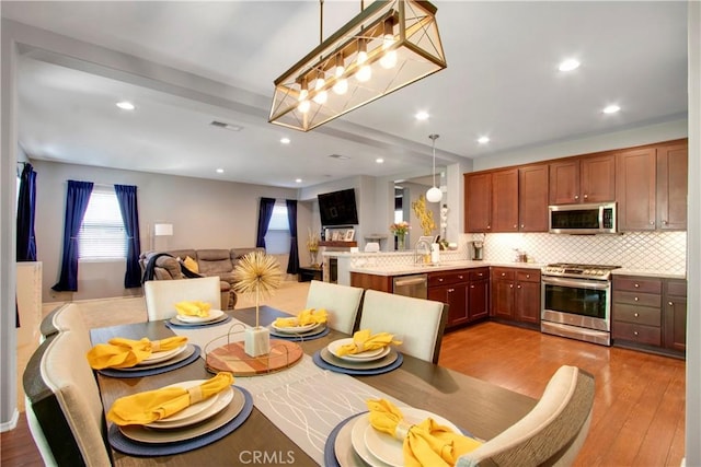 dining room with hardwood / wood-style flooring and sink