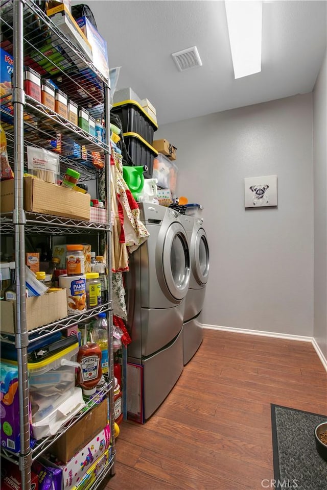 washroom featuring washer and dryer and dark hardwood / wood-style flooring