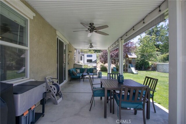 view of patio with an outdoor living space, ceiling fan, and a playground