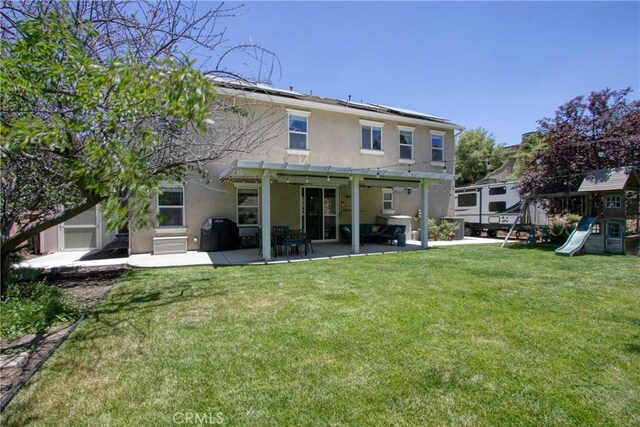 rear view of house with a yard, a playground, a patio, and a pergola