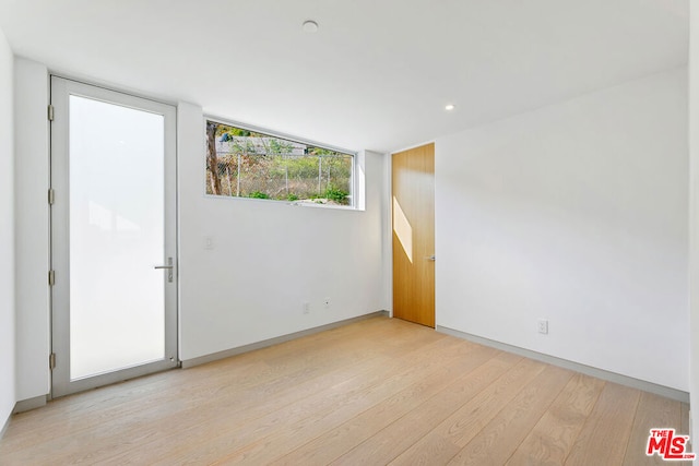 empty room with light hardwood / wood-style flooring