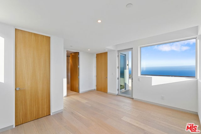 empty room with light hardwood / wood-style flooring