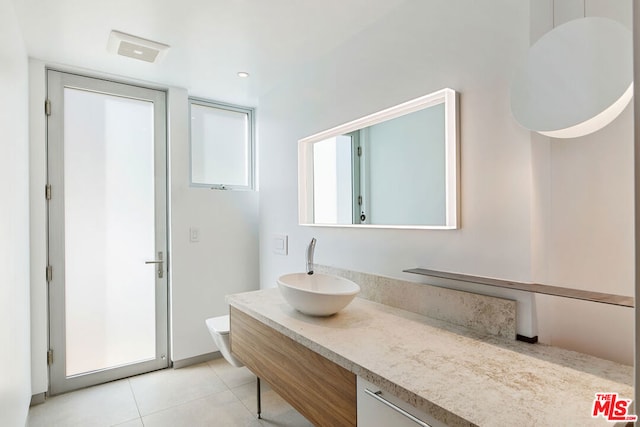 bathroom featuring tile patterned flooring, vanity, and toilet